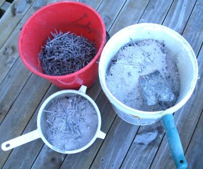 Sifting out the nails from the ash.